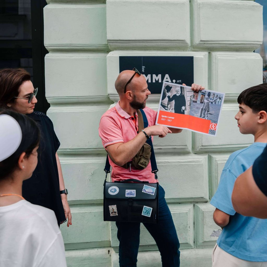 A guide showing to the clients booklet during Bratislava Grand City Tour