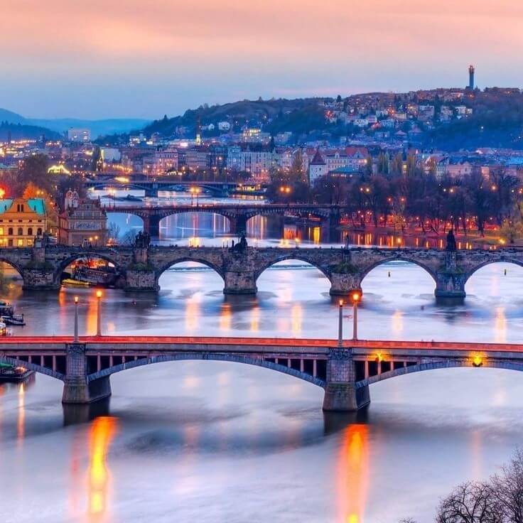 Prague's bridges over Vltava river in Prague at dusk during Central Europe Itinerary 