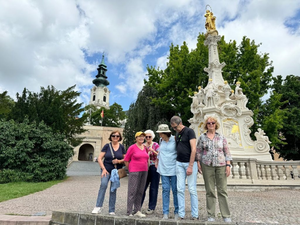 Nitra Castle during 6 day pilgrimage across Slovakia: Sacred Sites & spiritual heritage. The clients from Spain posing in front of plague column. 