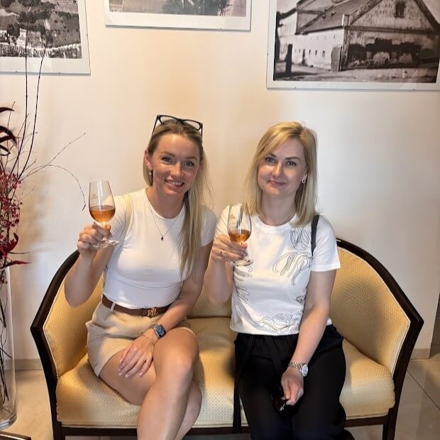 Mead tasting in Medolandia, Dolna Krupa. Two blond ladies posing with frizzante from honey liquor. 