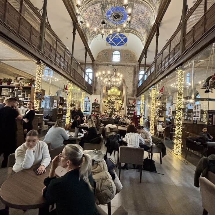 Interior of Synagogue Café Trnava in converted 1891 Orthodox synagogue with guests, Slovakia
