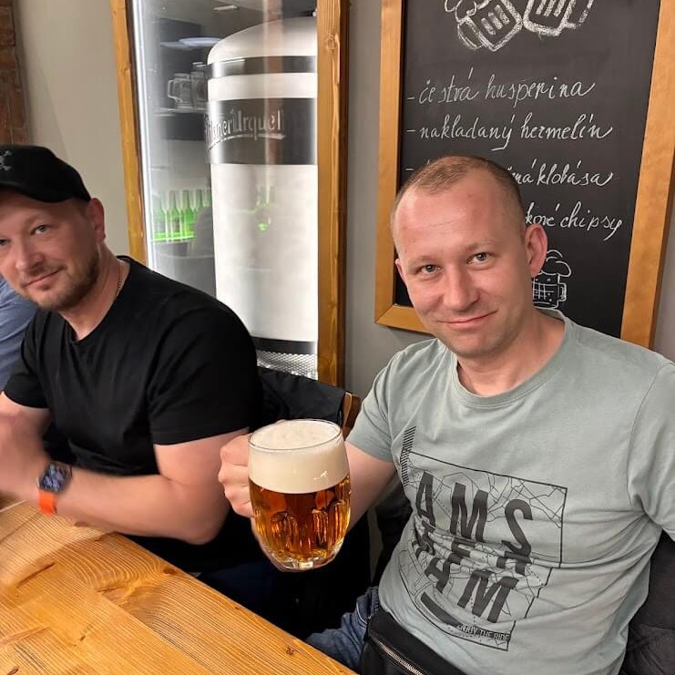 Two men enjoying craft beer tasting at a Bratislava pub