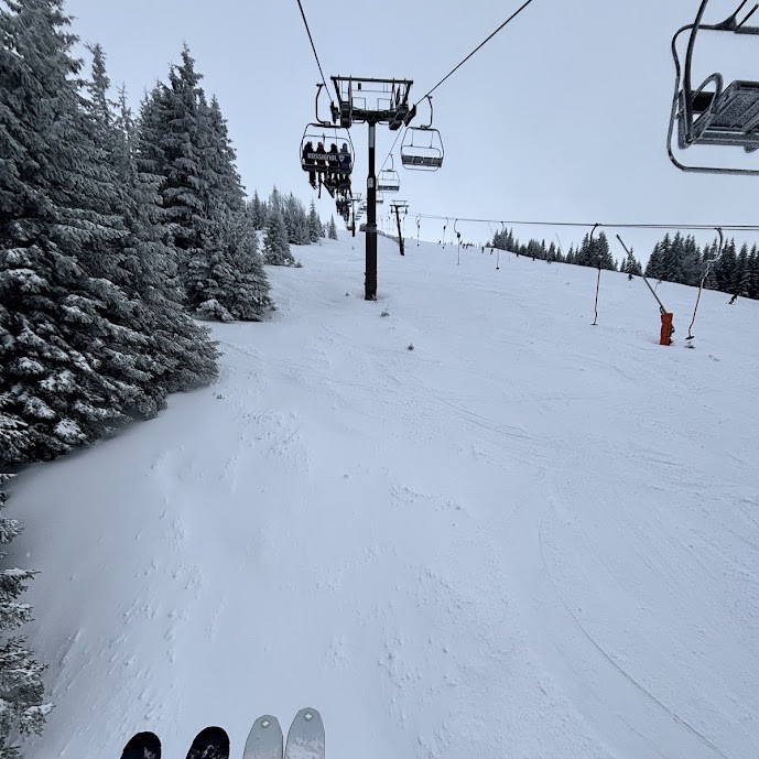 First-person view from a chairlift over a fresh snow piste at Jasná in the Low Tatras, one of the best ski resorts in Slovakia